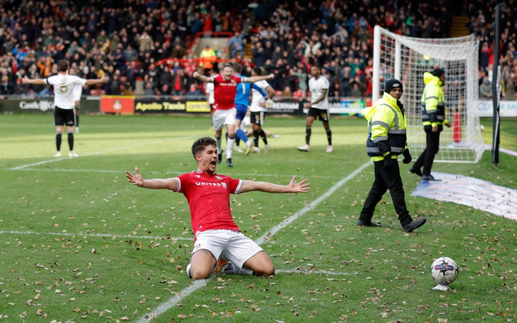 Jordan Davies celebrates scoring for Wrexham against Salford City.