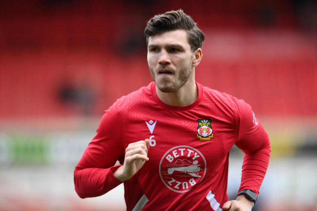 Wrexham defender Jordan Tunnicliffe warms up before facing Bradford City.