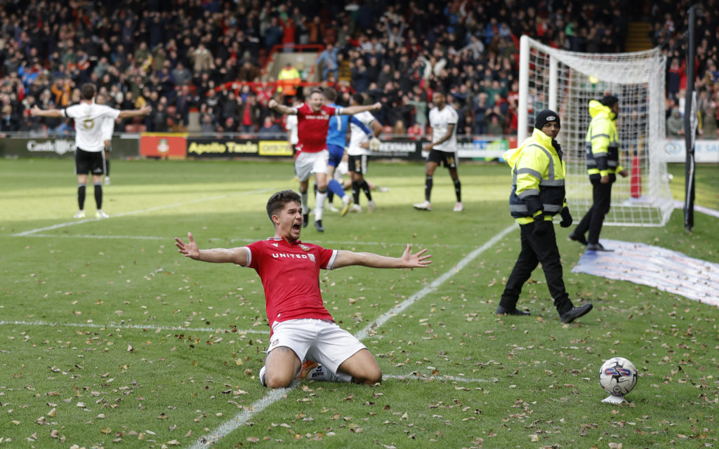 Jordan Davies celebrates scoring for Wrexham against Salford City.