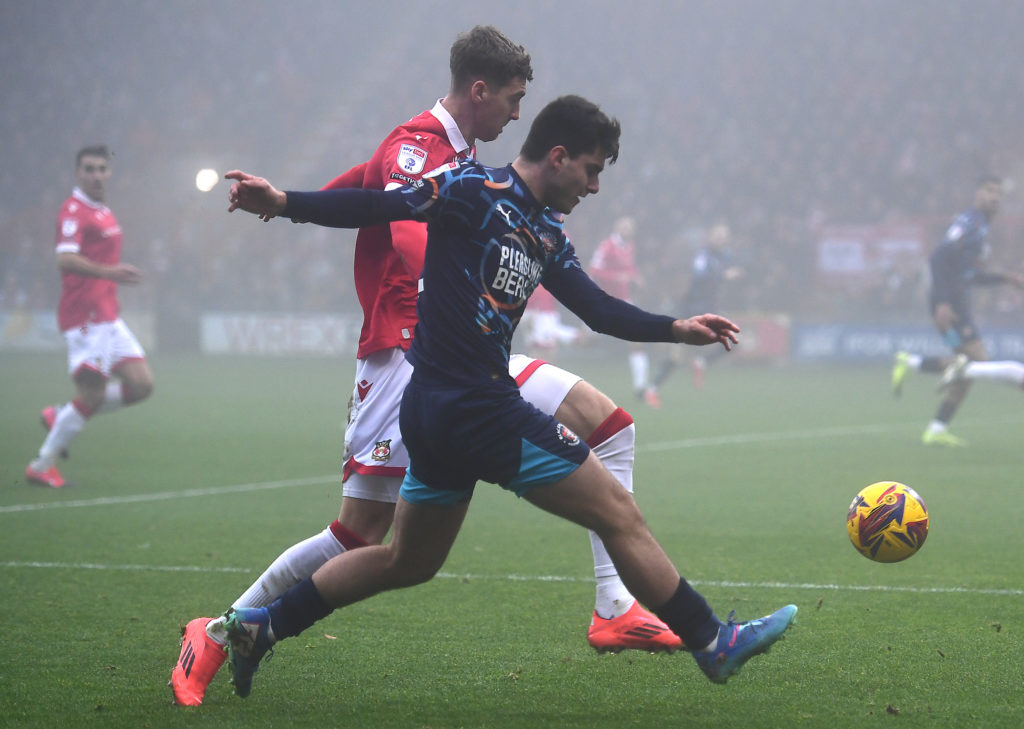 Blackpool's Rob Apter vies for possession with Wrexham's Lewis Brunt during the Sky Bet League One match between Wrexham AFC and Blackpool FC at  o...
