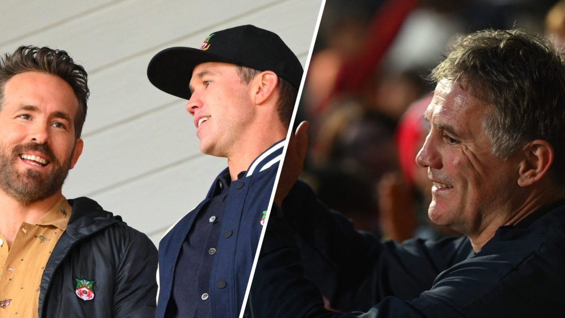 Wrexham owners Ryan Reynolds and Rob McElhenney look on at the Racecourse Ground. Manager Phil Parkinson celebrates.