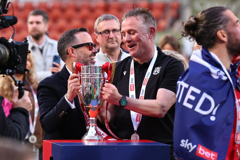 Phil Parkinson lifts the Sky Bet League One trophy after Wrexham AFC v Charlton Athletic FC.
