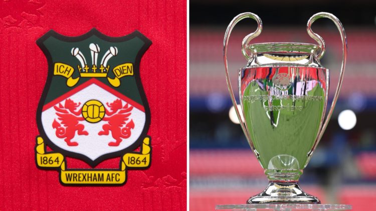 The official club badge of Wrexham AFC on a home shirt. A detailed view of the UEFA Champions League trophy is seen on a plinth prior to the UEFA C...