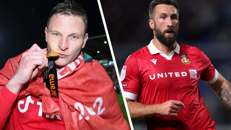 Paul Mullin of Wrexham kisses his champions winner medal as Wrexham celebrate promotion back to the English Football League during the Vanarama Nat...