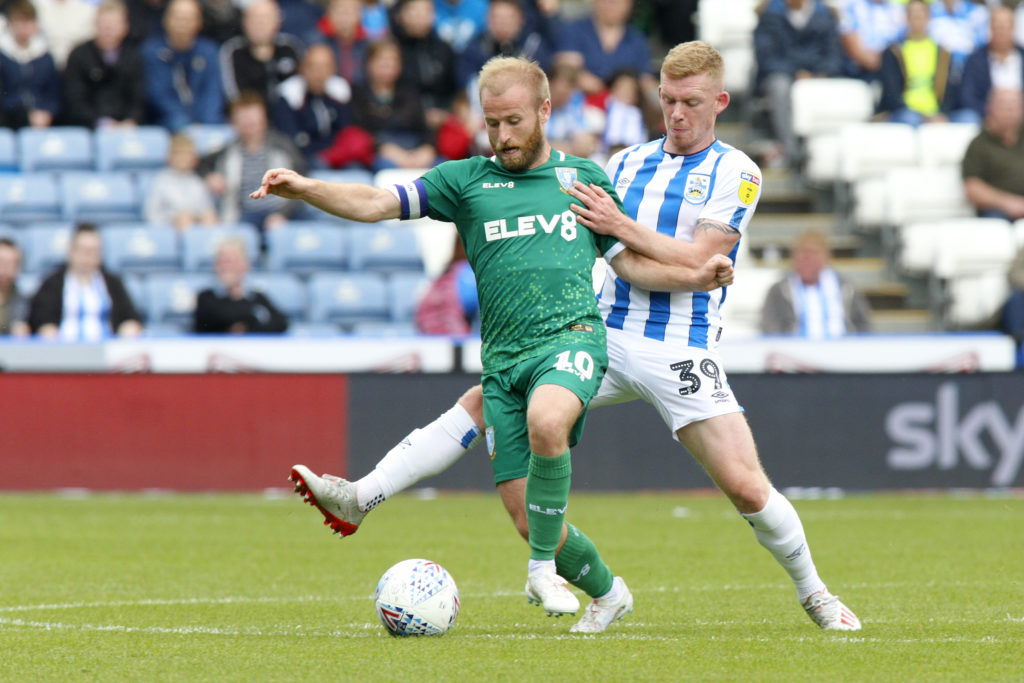 Huddersfield Town's Lewis O'Brien in action against Sheffield Wednesday's Barry Bannan.