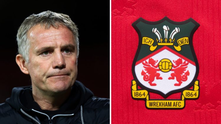 The official club badge of Wrexham AFC on a home shirt. Phil Parkinson looks on prior to the Bristol Street Motors Trophy match between Wrexham and...