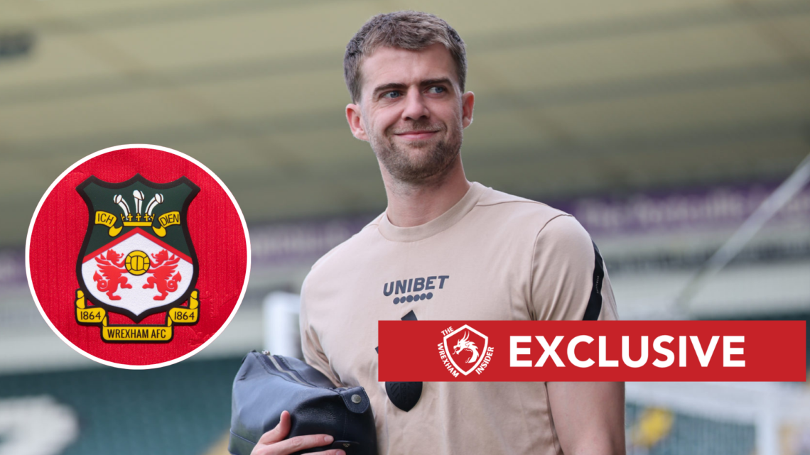 Patrick Bamford of Leeds United. The official club badge of Wrexham AFC on a home shirt.