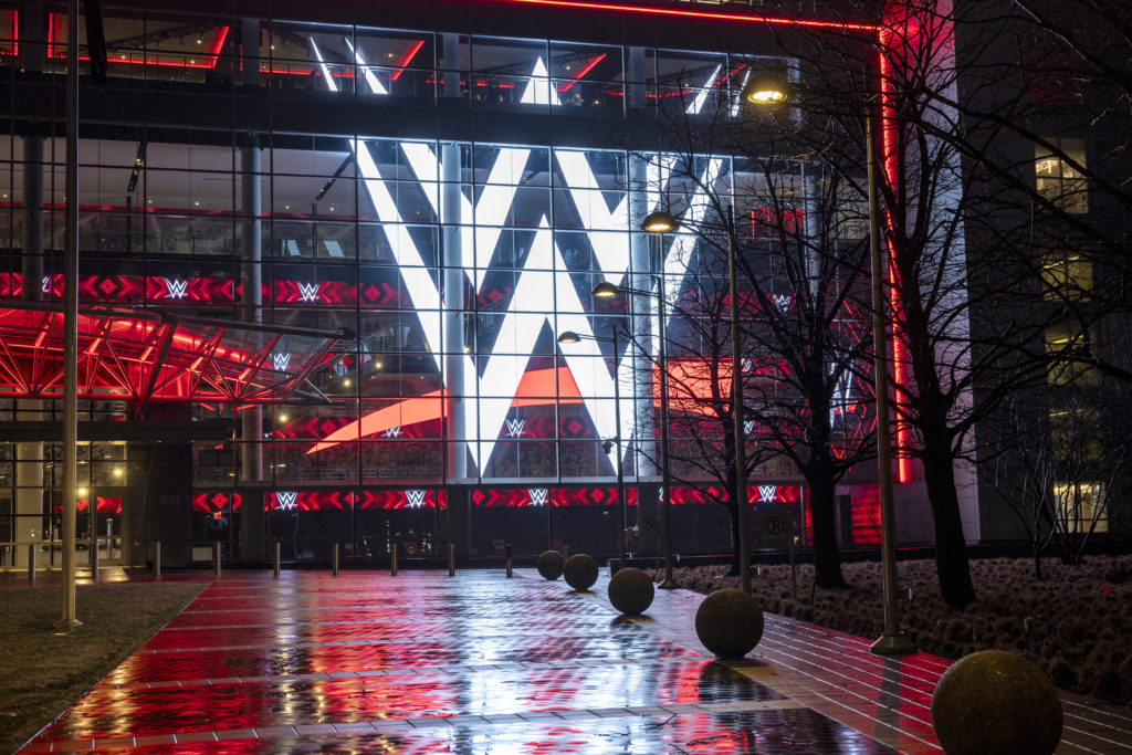 A giant WWE logo shines from the WWE world headquarters