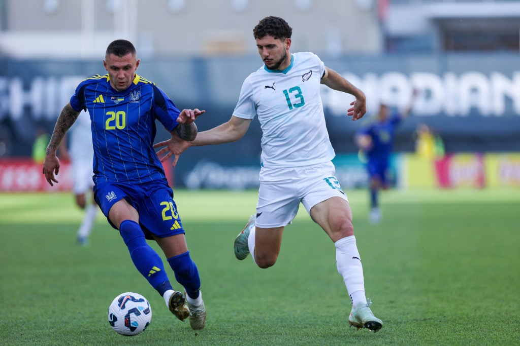 n Toronto, Ontario, Canada, on June 10, 2025, Oleksandr Zubkob #20 (blue) carries the ball while Liberato Cacace #13 (white) of New Zealand chases him