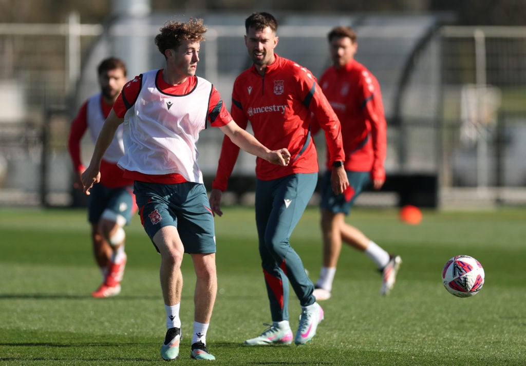 Wrexham's Harry Ashfield and Ryan Hardie look on in training.