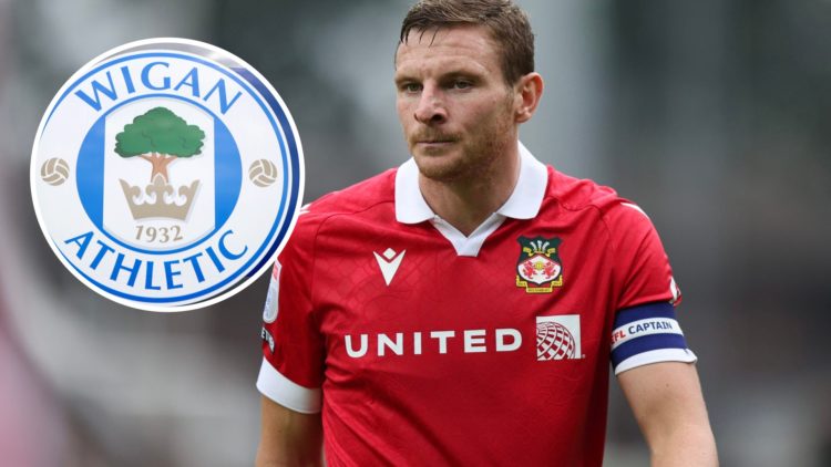 Paul Mullin of Wrexham during the Sky Bet League One match between Wrexham AFC and Shrewsbury Town. The club crest of Wigan Athletic is seen outsid...