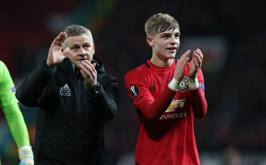 Manager Ole Gunnar Solskjaer and Brandon Williams of Manchester United walk off