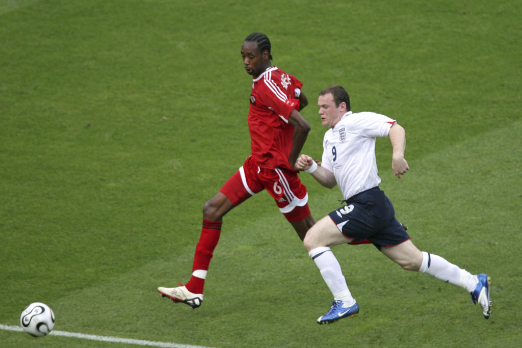 Trinidad and Tobago's Dennis Lawrence defends against England's Wayne Rooney