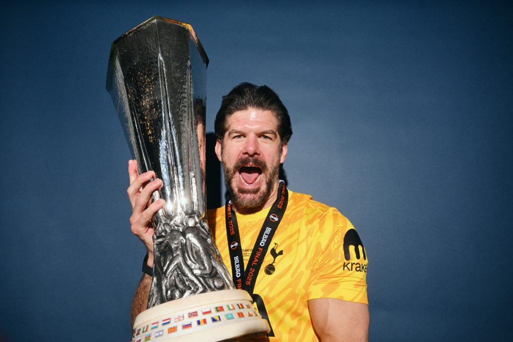 Fraser Forster of Tottenham Hotspur poses for a photo with the UEFA Europa League Trophy