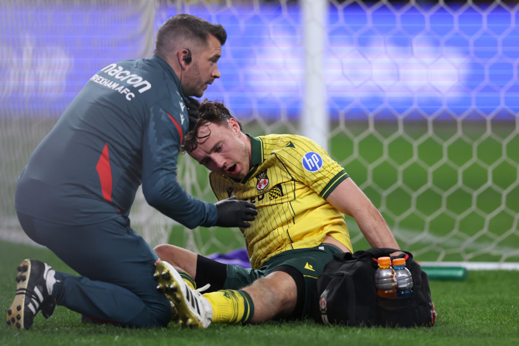 Ollie Rathbone of Wrexham AFC sustains an injury