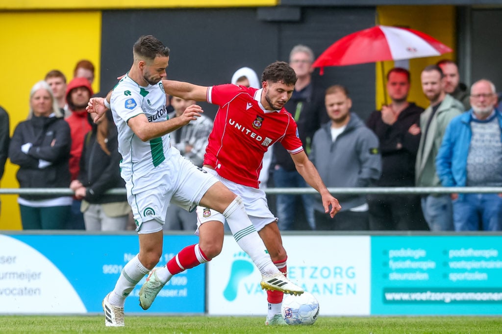 Marco Rente of FC Groningen battles for the ball with Liberato Cacace of Wrexham