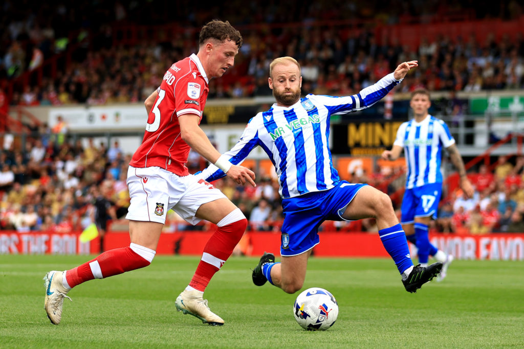 Nathan Broadhead of Wrexham is challenged by Barry Bannan of Sheffield Wednesday