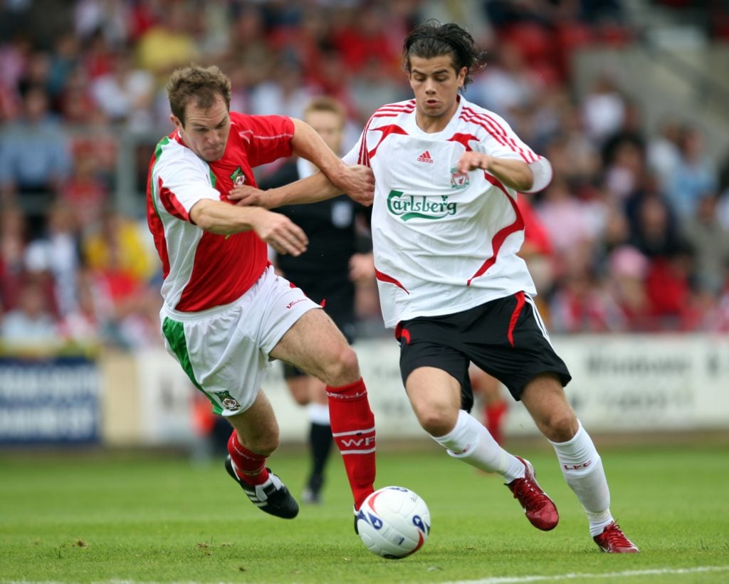 Jordy Brouwer of Liverpool and Shaun Pejic of Wrexham in action
