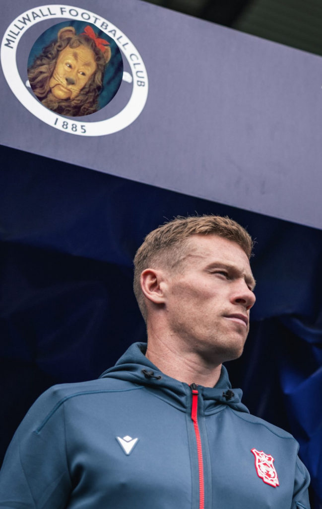 James McClean walks out at The Den. The Cowardly Lion has replaced the Millwall badge above.