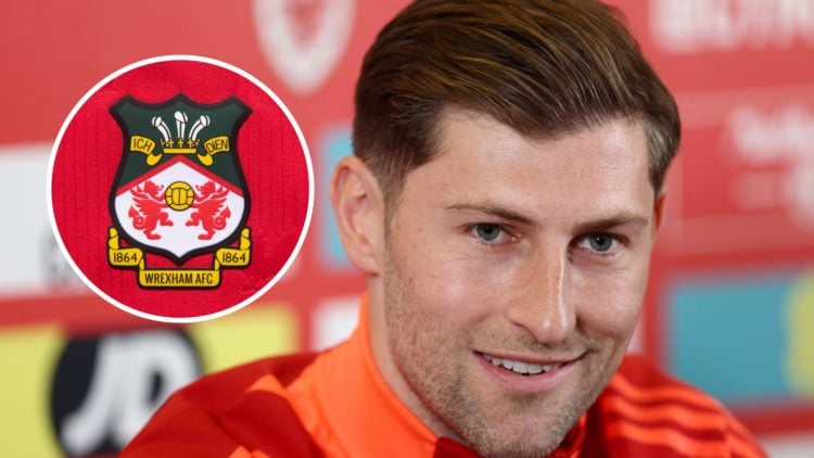 Ben Davies of Wales speaking to the media. The official club badge of Wrexham AFC on a home shirt.