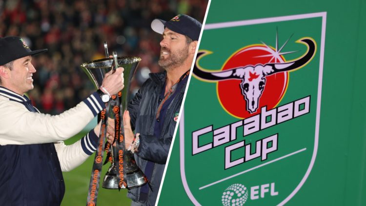 Rob McElhenney and Ryan Reynolds hold the Vanarama National League Trophy as Wrexham celebrate promotion back to the English Football League. A det...