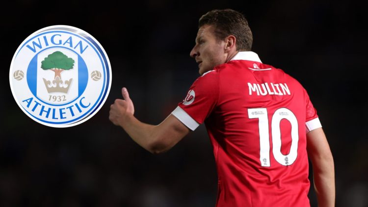 Paul Mullin in action during Birmingham City FC v Wrexham AFC in the Sky Bet League One clash. The club crest of Wigan Athletic is seen outside DW ...