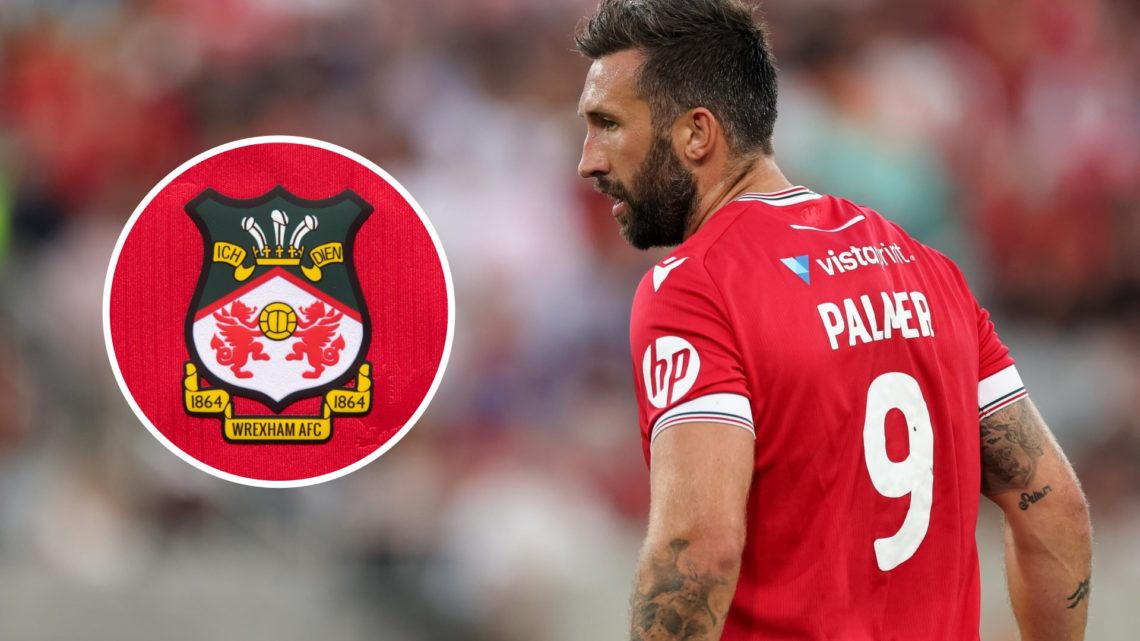 Ollie Palmer during Manchester United v Wrexham - Pre-Season Friendly. The official club badge of Wrexham AFC on a home shirt.