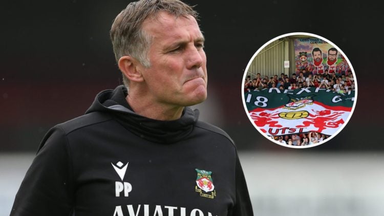 Phil Parkinson looks on prior to the Vanarama National League match between Dagenham and Redbridge and Wrexham. Fans of Wrexham display a flag of t...