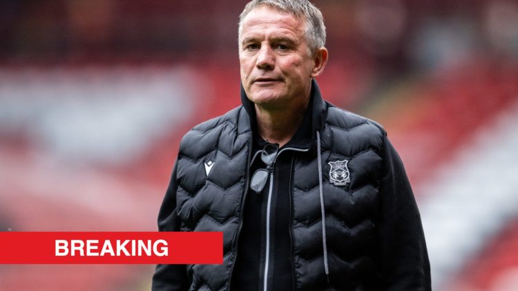 Wrexham boss Phil Parkinson looks on before facing Charlton Athletic. Inset, a red banner with 'breaking' in white text.