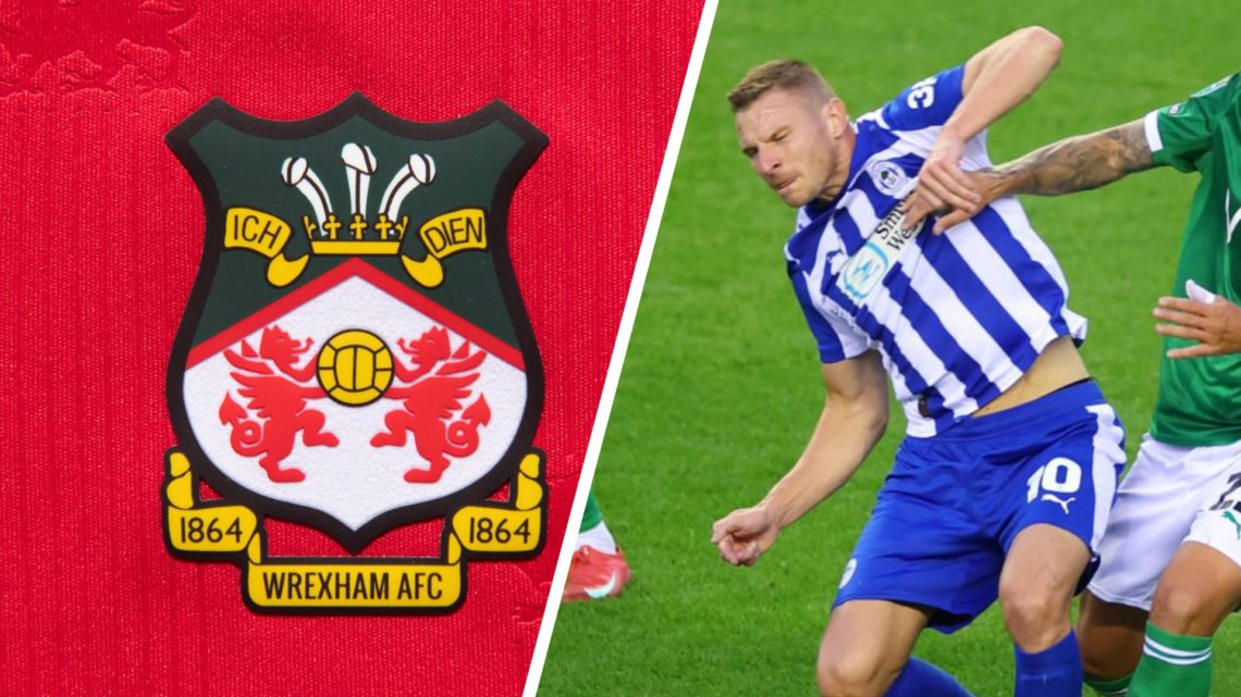 The official club badge of Wrexham AFC on a home shirt. Paul Mullin during Wigan Athletic v Stockport County - Carabao Cup Second Round.