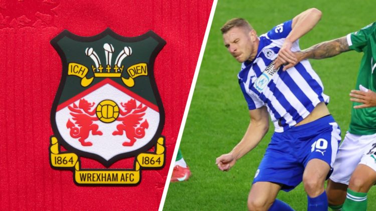 The official club badge of Wrexham AFC on a home shirt. Paul Mullin during Wigan Athletic v Stockport County - Carabao Cup Second Round.