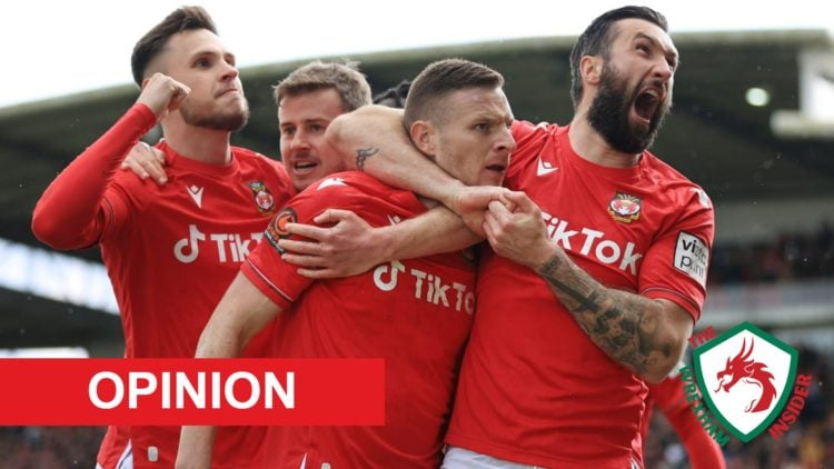 Wrexham players including Paul Mullin and Ollie Palmer celebrate a goal.