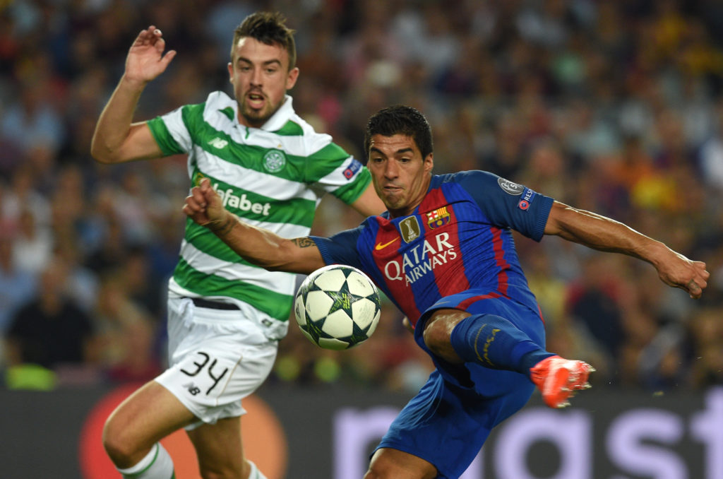 Barcelona's Uruguayan forward Luis Suarez shoots to score a goal beside Celtic's Irish defender Eoghan O'Connell (L)