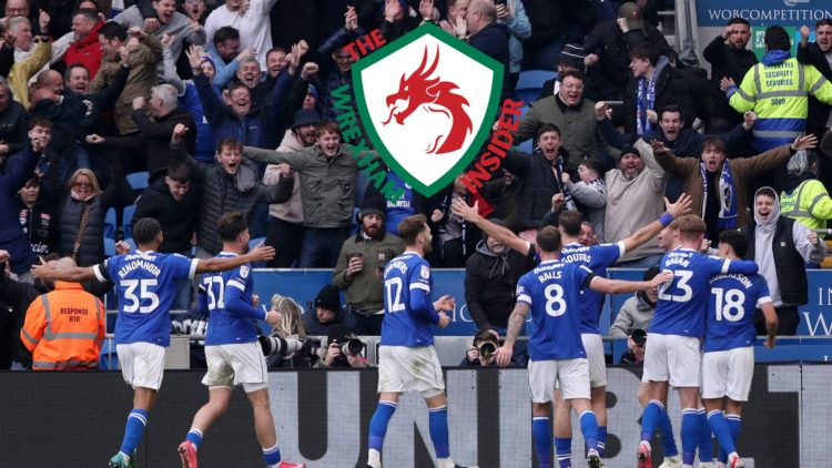 Cardiff City players celebrate a goal in front of their fans.