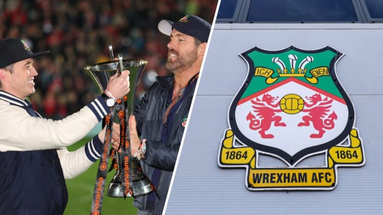 Rob McElhenney and Ryan Reynolds hold the Vanarama National League Trophy as Wrexham celebrate promotion back to the English Football League. An ex...