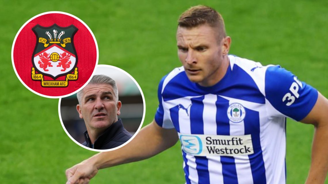Paul Mullin in action for Wigan Athletic v Stockport County. Wigan Athletic's manager Ryan Lowe. The official club badge of Wrexham AFC on a home s...
