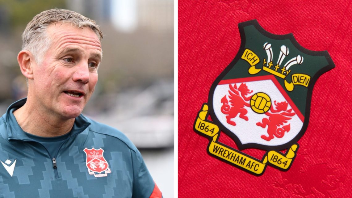 Phil Parkinson the coach of Wrexham speaks to the media. Wrexham badge on a red home shirt.