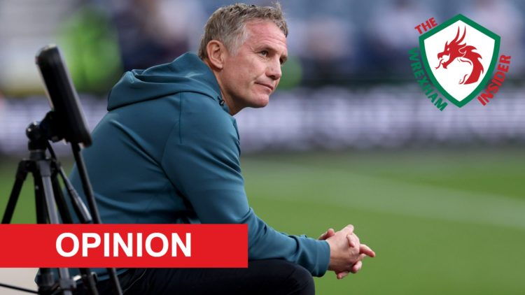 Wrexham manager Phil Parkinson sits on the touchline.