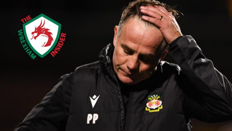 Wrexham manager Phil Parkinson stands on the touchline.