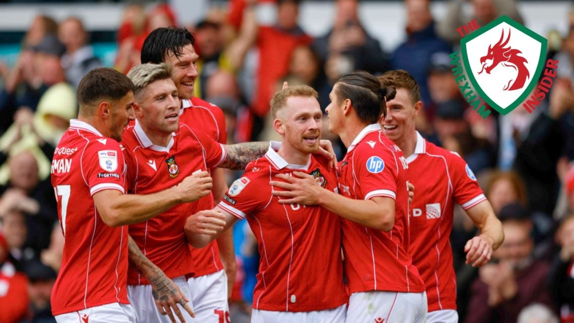 The Wrexham players celebrate scoring a goal.
