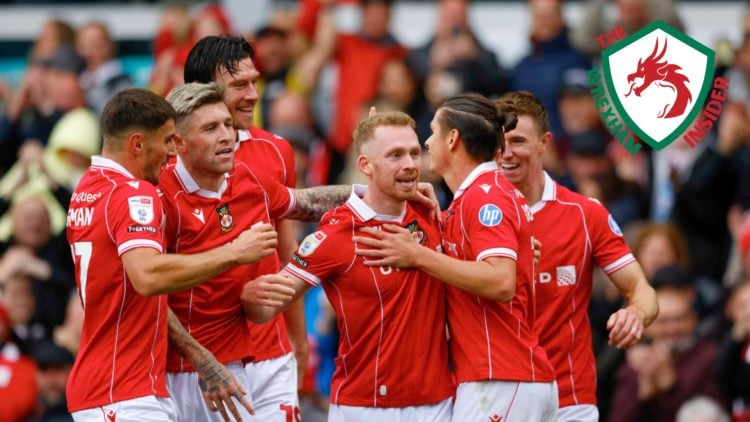 The Wrexham players celebrate scoring a goal.