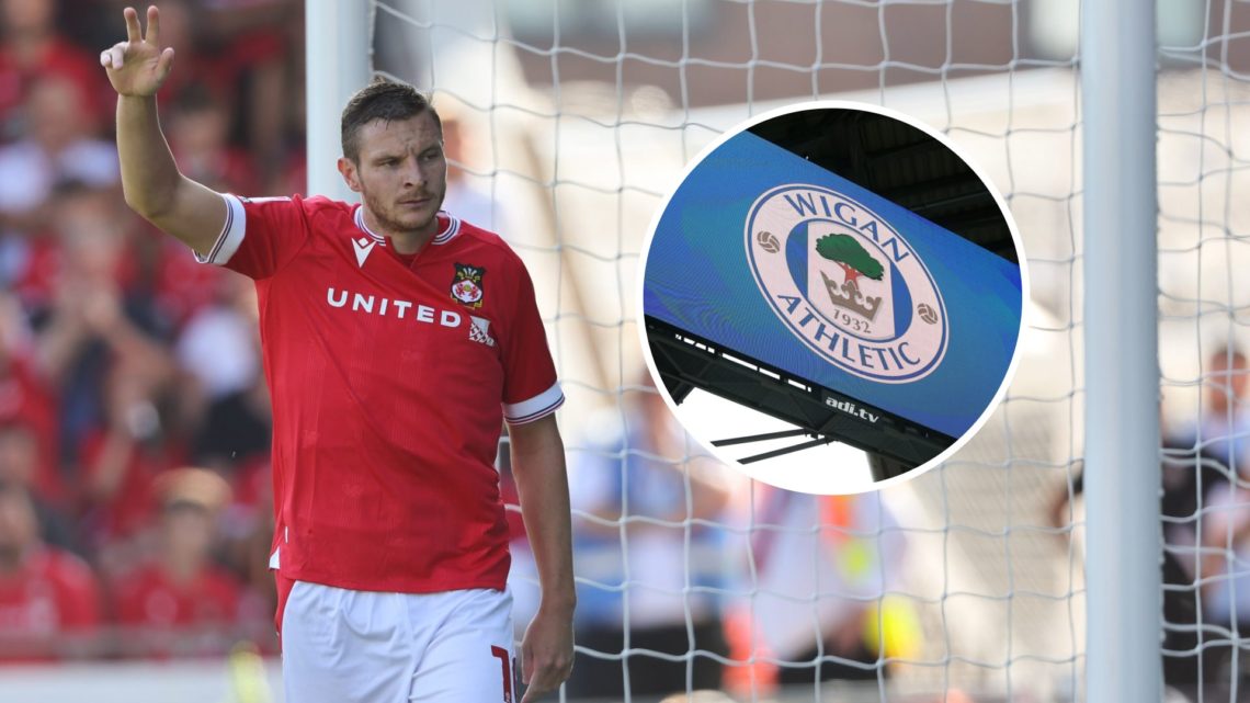 Paul Mullin during Wrexham v Doncaster Rovers - Sky Bet League Two. The club crest of Wigan Athletic is seen on a big screen inside DW Stadium.
